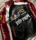 Ferrari leather jacket with branding and logos on a neutral background